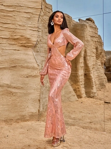 Pink sequin long sleeve evening gown with V-neck and waist cutouts in desert setting