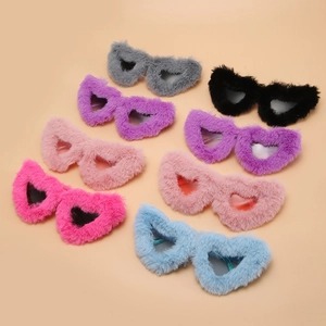 Collection of plush heart-shaped party sunglasses in multiple colors on pink background