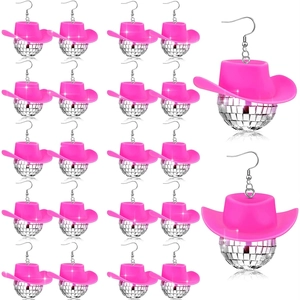 Macro detail of pink cowboy hat and silver disco ball earrings on white background