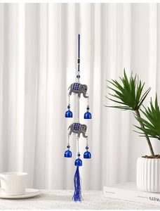 Detail of blue elephant wind chime with crystal accents and hanging blue tassels