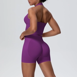 Detail of purple seamless knitted yoga set featuring halter neck top and lifting shorts