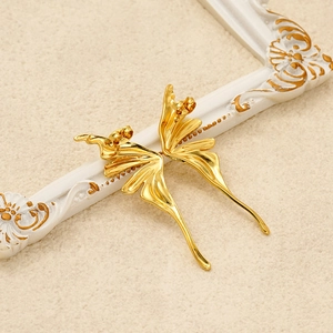 Vintage style gold titanium steel butterfly wing earrings on a white frame background