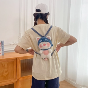 Cute cat plush backpack in white and pink with blue hood shown on model's back