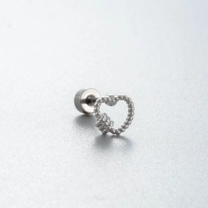 Silver-colored heart-shaped ear stud with a beaded texture design on a neutral background