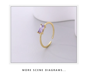 Detailed macro view of a gold 925 silver ring featuring a rectangular purple gemstone
