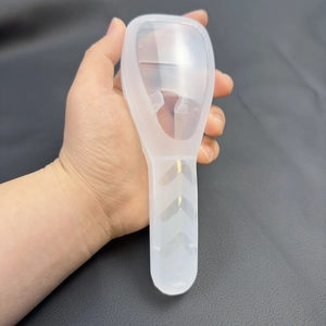 Translucent white silicone razor case with anti-slip grip held by hand on dark background