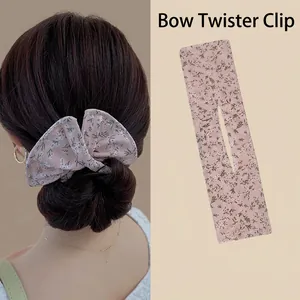 Detail of pink floral fabric hair bun maker showing model styling and product texture