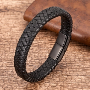 Detail of a black braided leather bracelet featuring a sleek black magnetic steel clasp