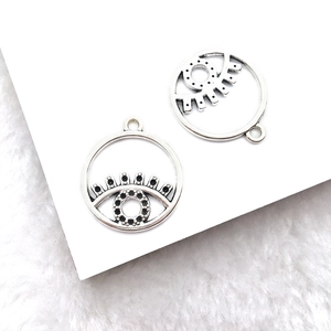 Detailed close-up of alloy Eye of Horus charms with silver finish and black rhinestones