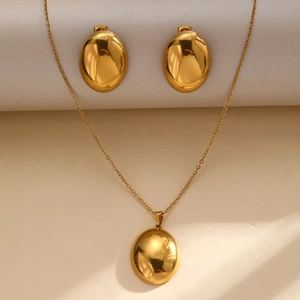 Elegant gold-tone stainless steel jewelry set featuring oval geometric pendant and studs
