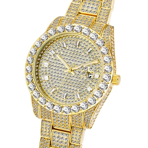 Macro shot of gold hip hop watch featuring full iced-out diamond dial and bezel detailing