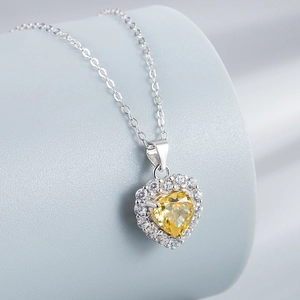 925 sterling silver necklace featuring a yellow heart-shaped pendant with a halo design