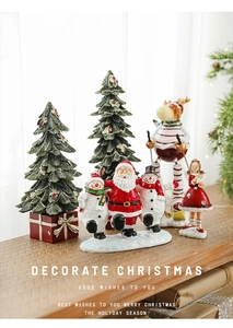 Detailed view of resin Christmas figurines including Santa and reindeer on wooden beam