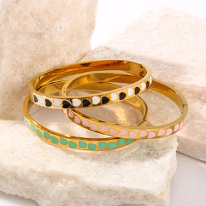Three-piece stackable 18K gold stainless steel bangles with colorful enamel heart patterns