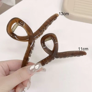 Detail showing amber large hair claw clip in 11cm and 13cm sizes with resin texture