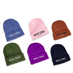 Multiple colors of New York embroidered knit beanies for men and women on white background