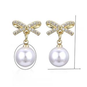 Detail view of pearl drop earrings with zircon bow and 22mm height dimensions