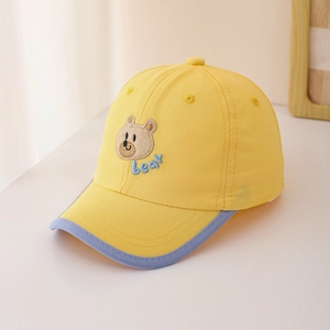 Détail de la casquette jaune pour bébé avec broderie ours et texture en coton fin