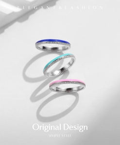 Close-up of stacked S925 sterling silver rings with colorful enamel and inlaid diamonds