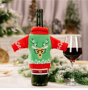 Detail of knitted Christmas wine bottle cover with cute reindeer design and holiday decor