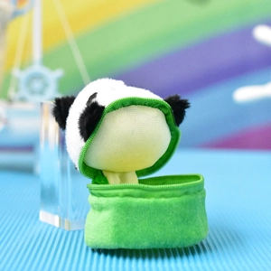 Detail view of cute panda plush head inside a green zippered coin purse keychain.