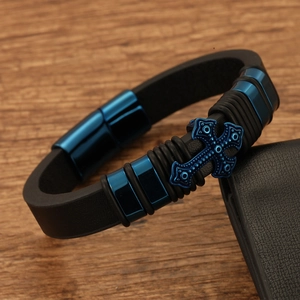 Retro titanium steel leather bracelet with blue metal cross on dark wooden surface