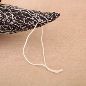 Detail of Halloween black fabric decoration with white mesh pattern and cotton rope