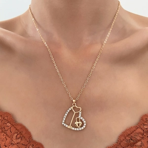 Golden infinity heart necklace with crystal key and lock pendant on female model