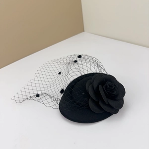 Vintage black mini top hat fascinator with camellia flower and polka dot mesh veil