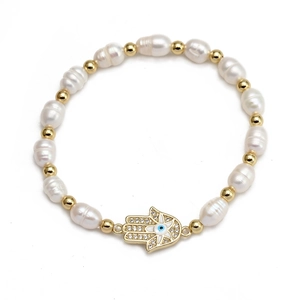 Detail of Hamsa Hand and Evil Eye charm with baroque pearls and golden beads bracelet