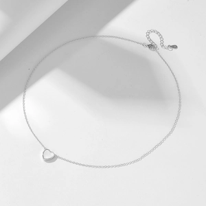 Macro shot of 925 sterling silver heart necklace with white mother of pearl inlay