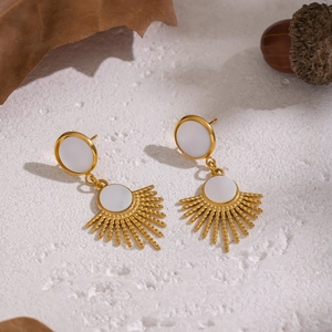 Detail of French vintage sunburst earrings featuring natural shell in gold plated steel