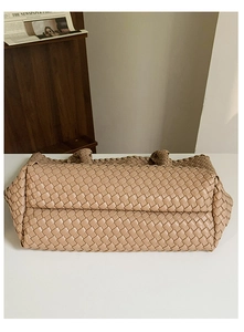 Detailed macro view showing the intricate woven leather base of the khaki tote bag