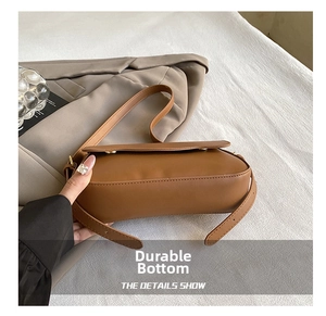 Detail shot of the wear-resistant bottom and side structure of the brown baguette bag