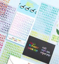 Close-up of pastel macaron alphabet and number stickers for DIY journaling