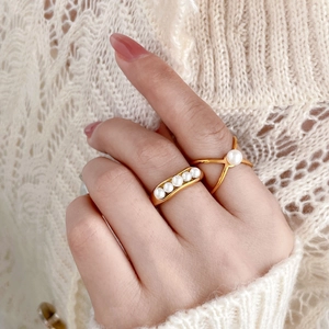 Elegant gold titanium pea-shaped freshwater pearl rings set on female hand