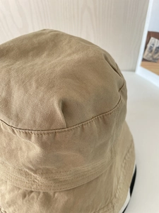 Close-up of khaki cotton bucket hat with detailed stitching on high-quality twill fabric
