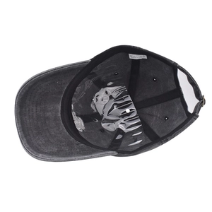 Detail of internal wash label showing 100% cotton material on washed denim baseball cap