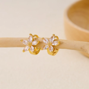 Elegant gold flower hoop earrings with marquise-cut cubic zirconia on a wooden stand