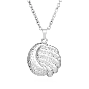 Macro shot of silver golf ball pendant necklace with detailed texture and fine metal chain