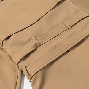 Detailed view of khaki trench coat waist belt with precision stitching and belt loops