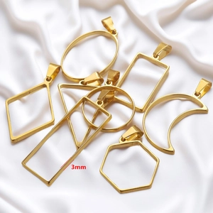Golden stainless steel geometric jewelry frames for DIY earrings on white silk background