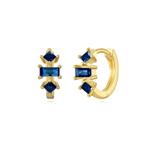 Detailed view of gold hoop earrings with emerald-cut blue zircons and sparkling crystals
