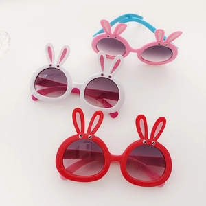 Detailed view of colorful rabbit ear kids sunglasses in red, white and pink blue tones