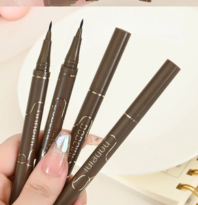 Close-up of four brown waterproof liquid eyeliners with precise 0.05mm tips for makeup
