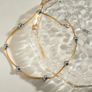 Two-tone stainless steel necklace featuring gold curved tubes and silver polished beads