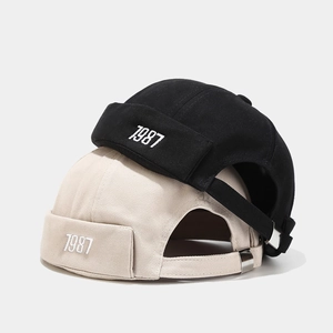 Cappelli docker nero e beige con ricamo 1987 e fibbia di regolazione in metallo
