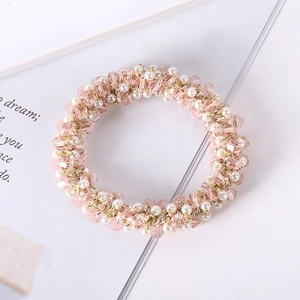 Detail of pink crystal beads and white pearls on a stylish handmade elastic hair tie