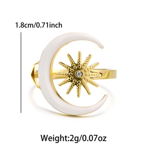 Detail shot of gold star and moon ring with white enamel and sparkling zircon inlay