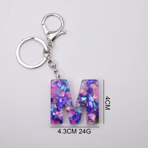 Colorful resin letter M keychain with mixed gemstones and silver lobster clasp detail